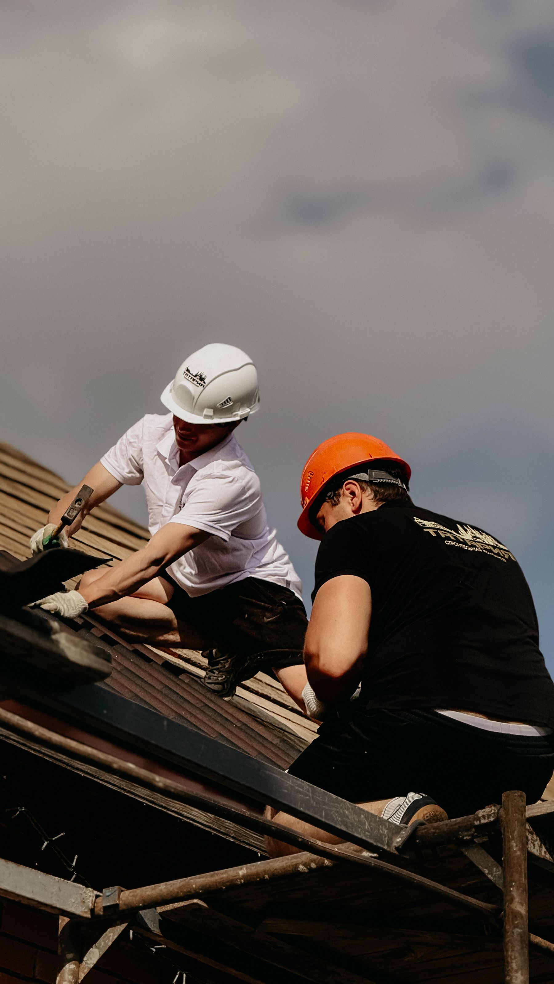 Roofing crew working together on a building